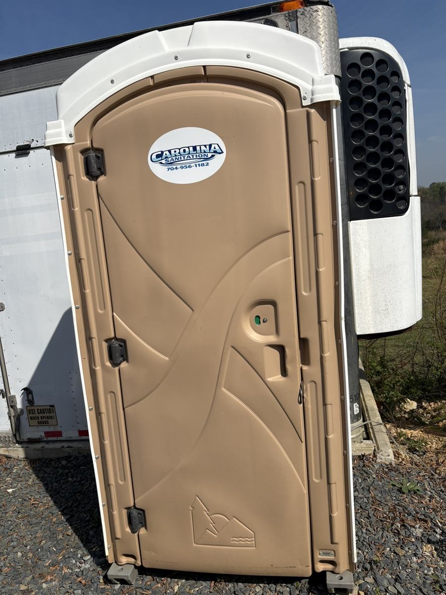 Carolina Sanitation porta-john — tan unit exterior with company logo